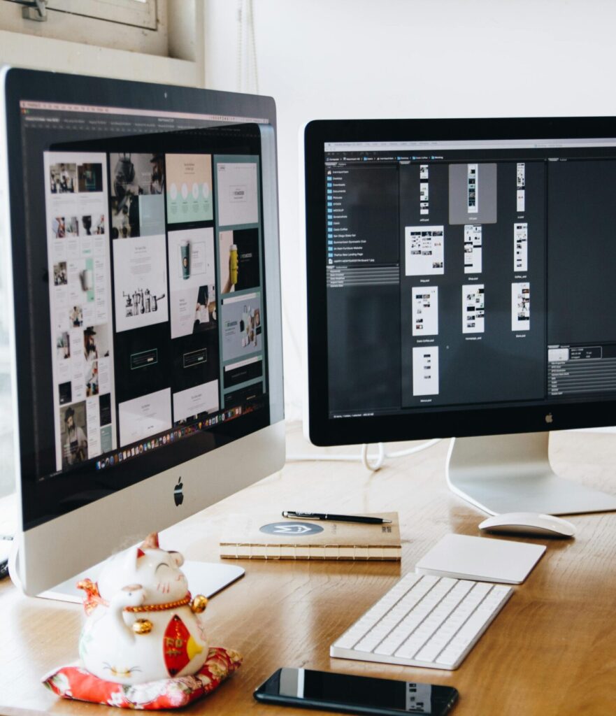 pexels-photo-326502-326502 A sleek modern office setup featuring dual monitors, Apple devices, and creative decor in an indoor workspace.