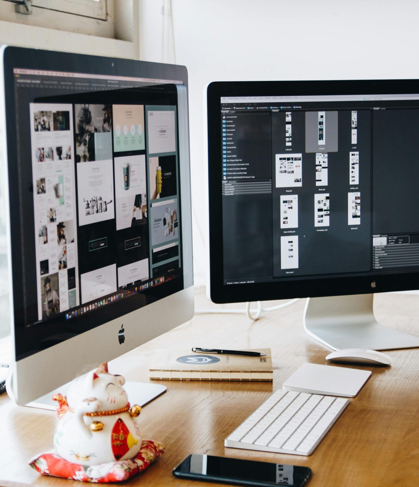 A sleek modern office setup featuring dual monitors, Apple devices, and creative decor in an indoor workspace.